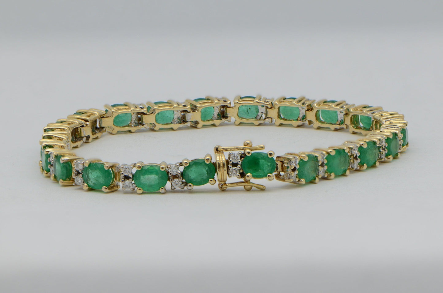 "BRAC01355" Oval Emerald and Round Diamond Yellow Gold Tennis Bracelet