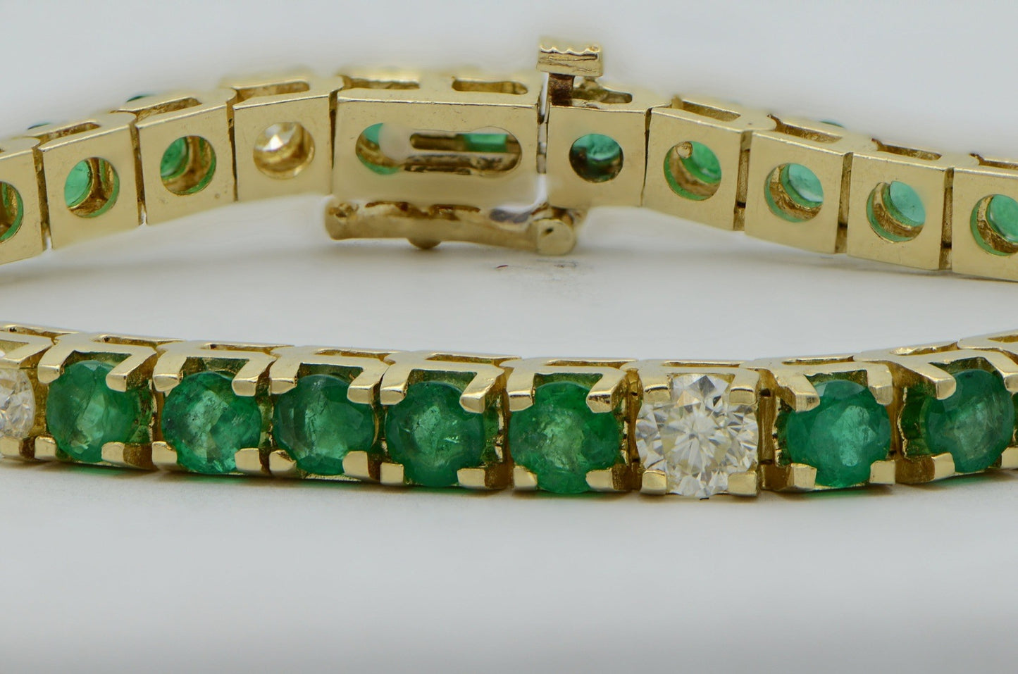 "BRAC01355" Oval Emerald and Round Diamond Yellow Gold Tennis Bracelet
