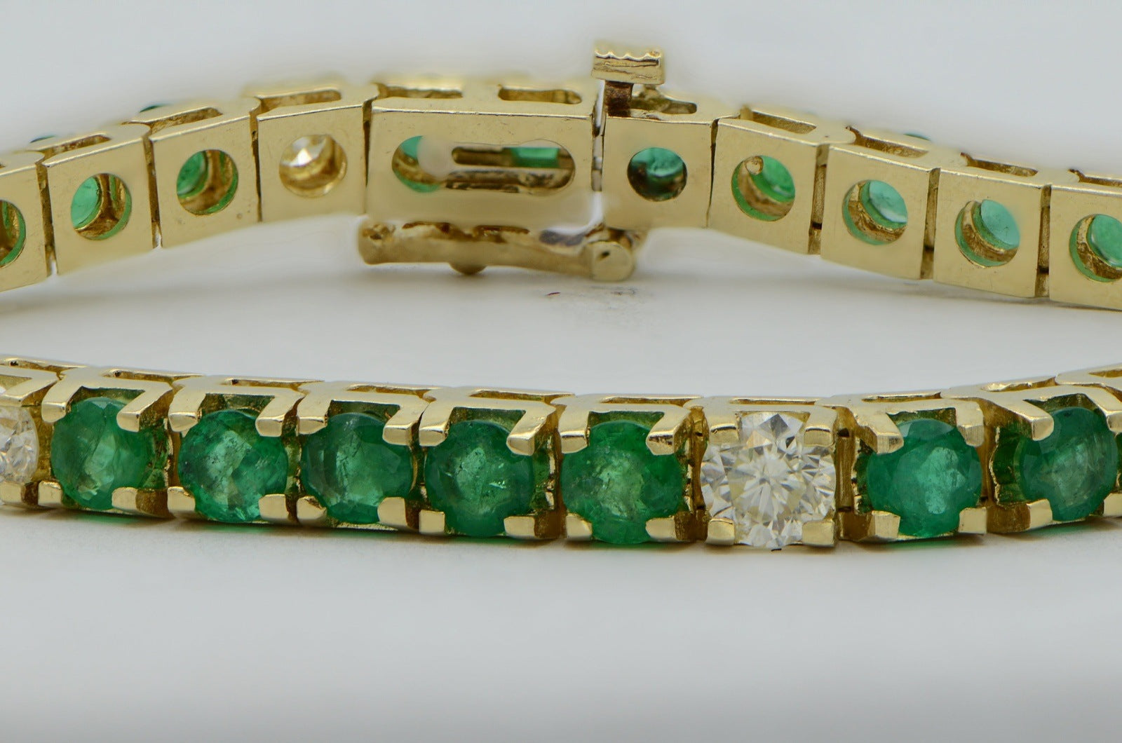 "BRAC01355" Oval Emerald and Round Diamond Yellow Gold Tennis Bracelet